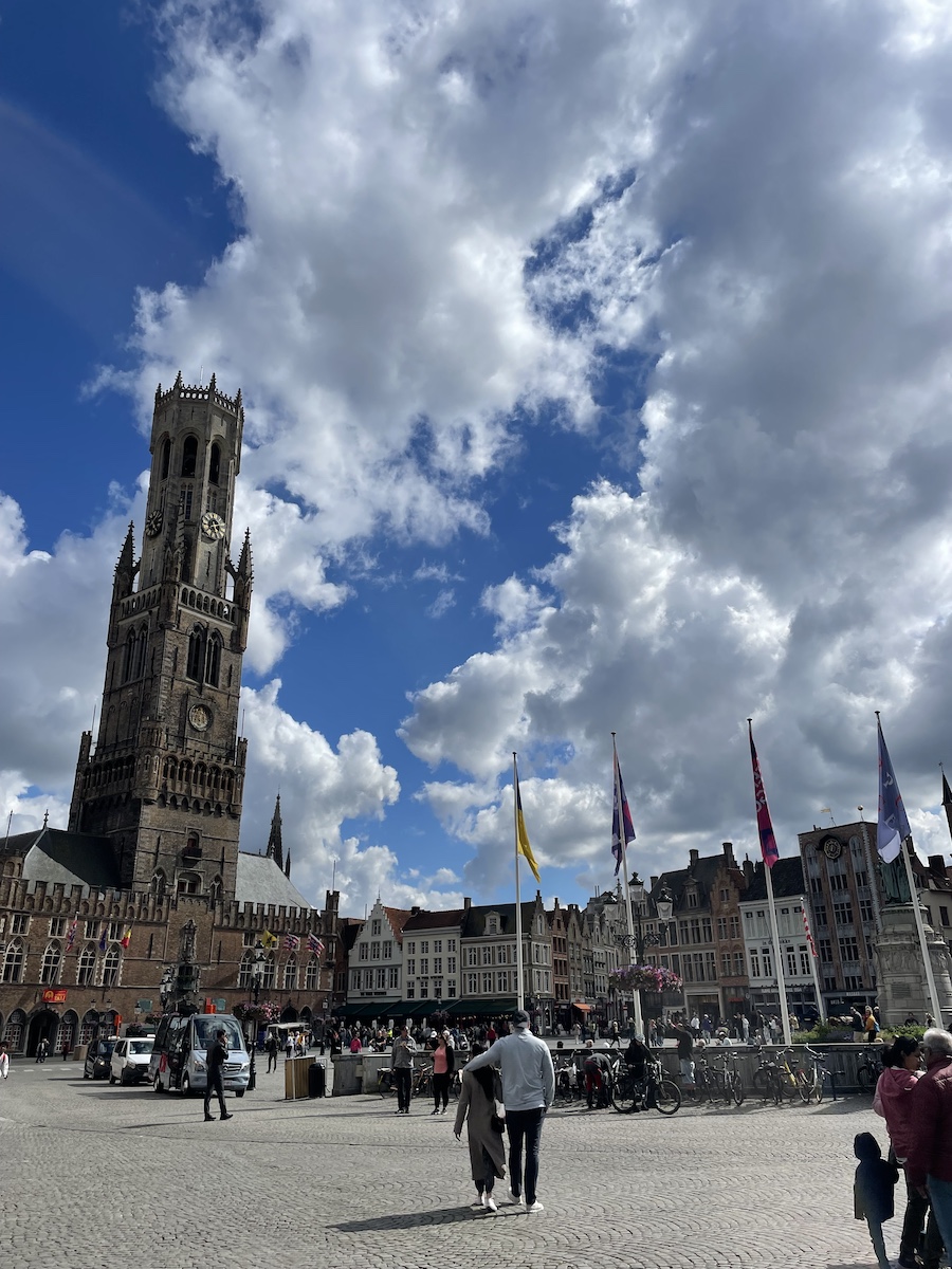 Town Market of Brugge, with flags and buildings surrounding square