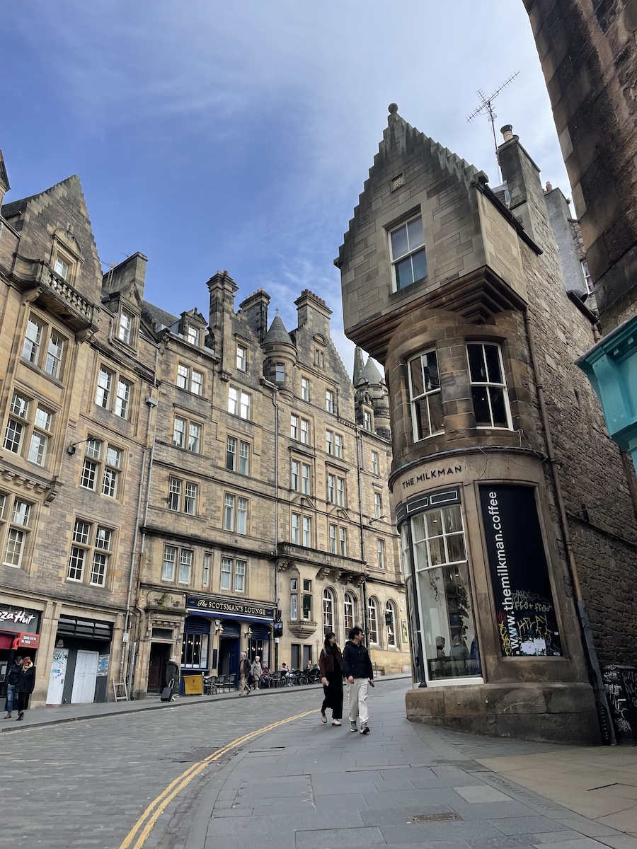 Tall brown buildings around the corner of a street