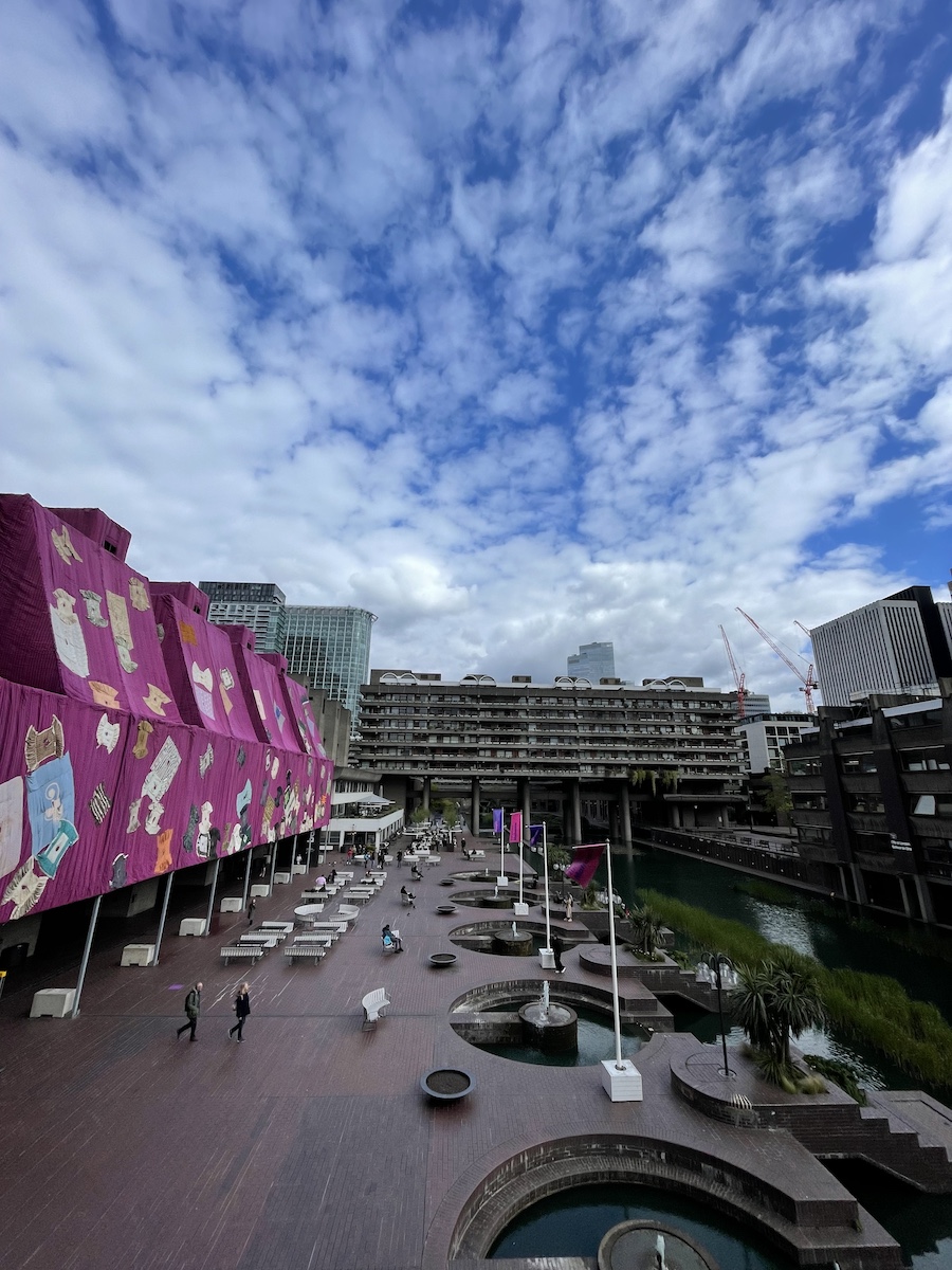 Elevated floor view of dock, with purple covered building on left, and canal on right