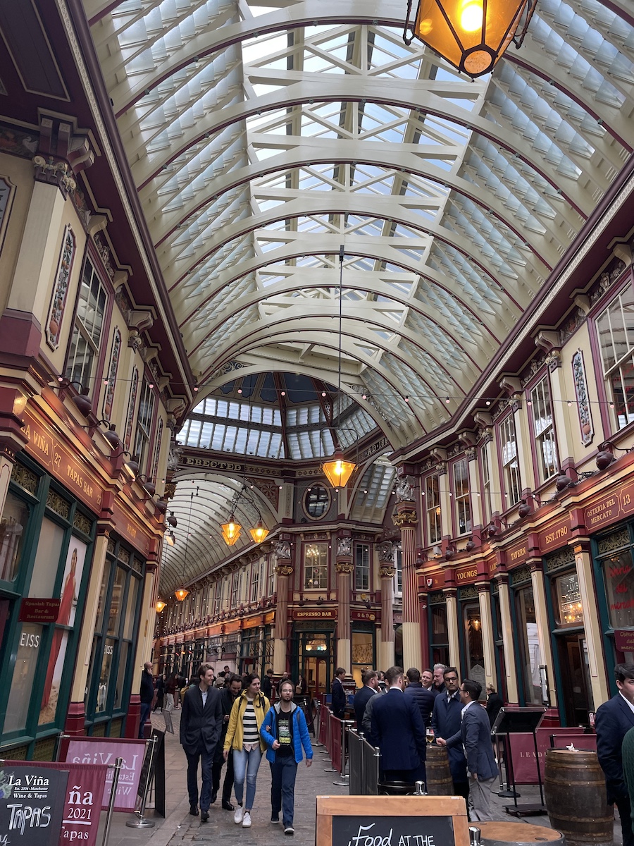 Long slightly curved hallway with orange walls, clear curved ceiling