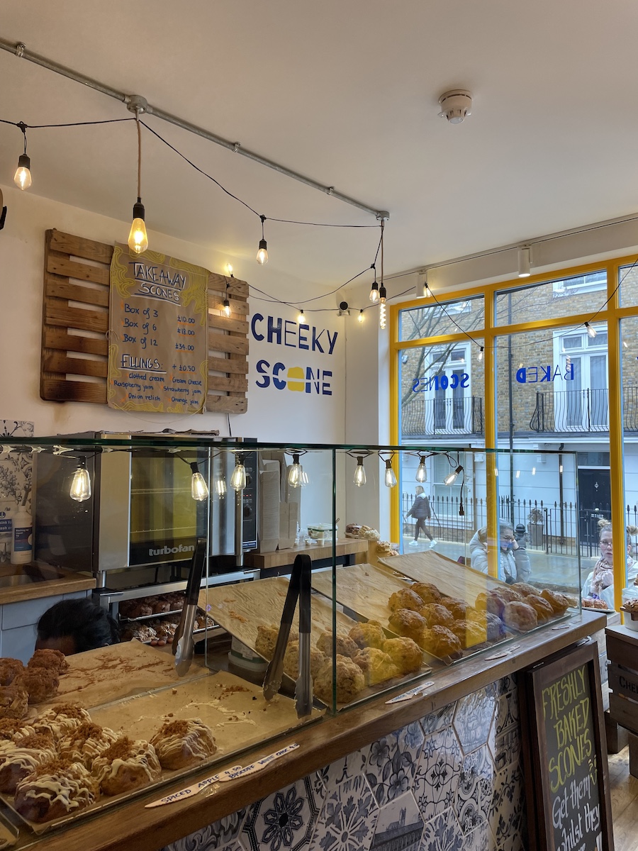 Scones behind glass cases with menu on back wall