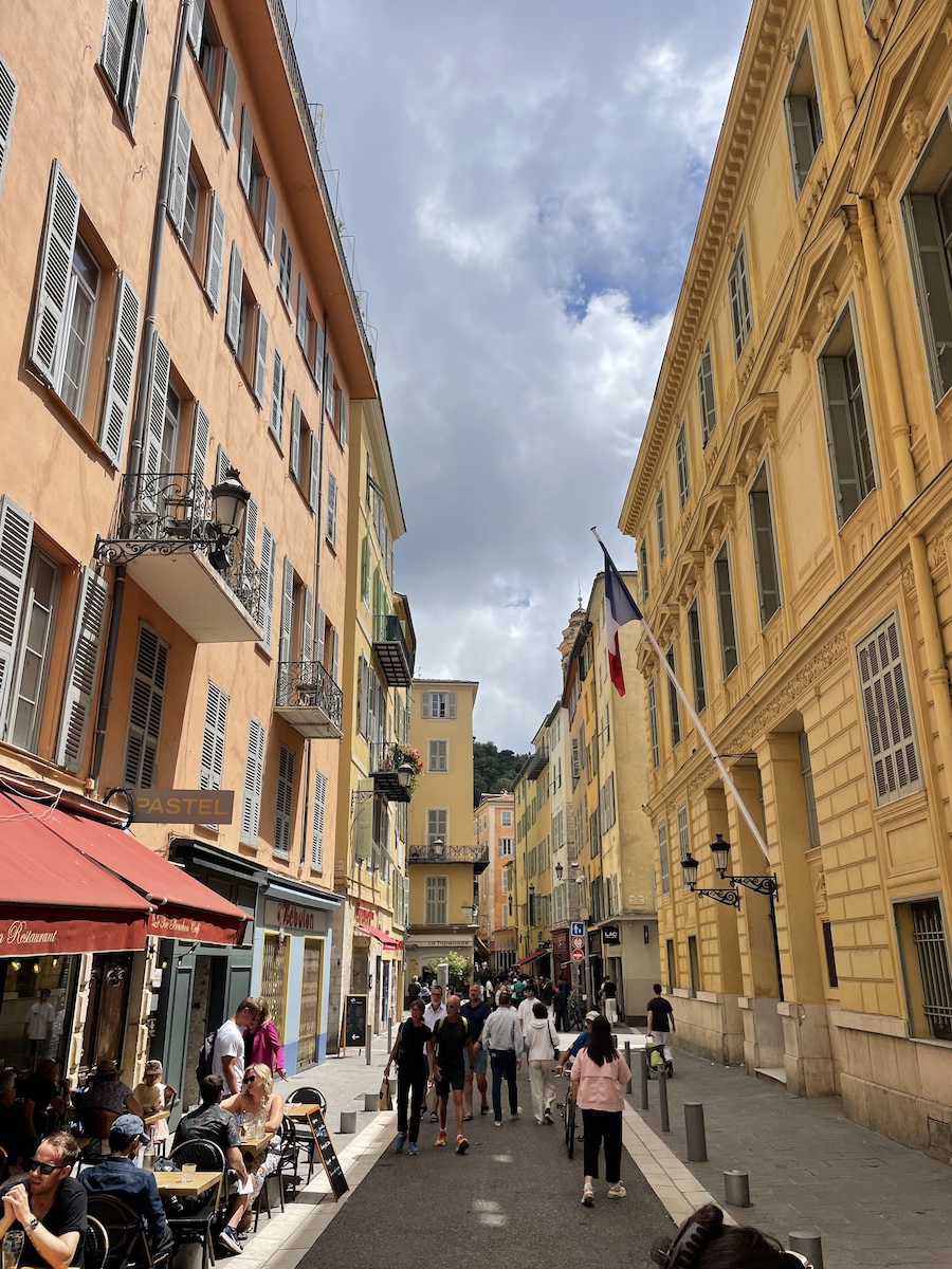 Narrow walkway with orange and yellow buildings