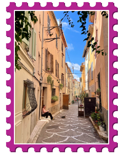 Walkway through tall yellow concrete buildings